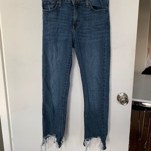Distressed jeans with ripped bottoms